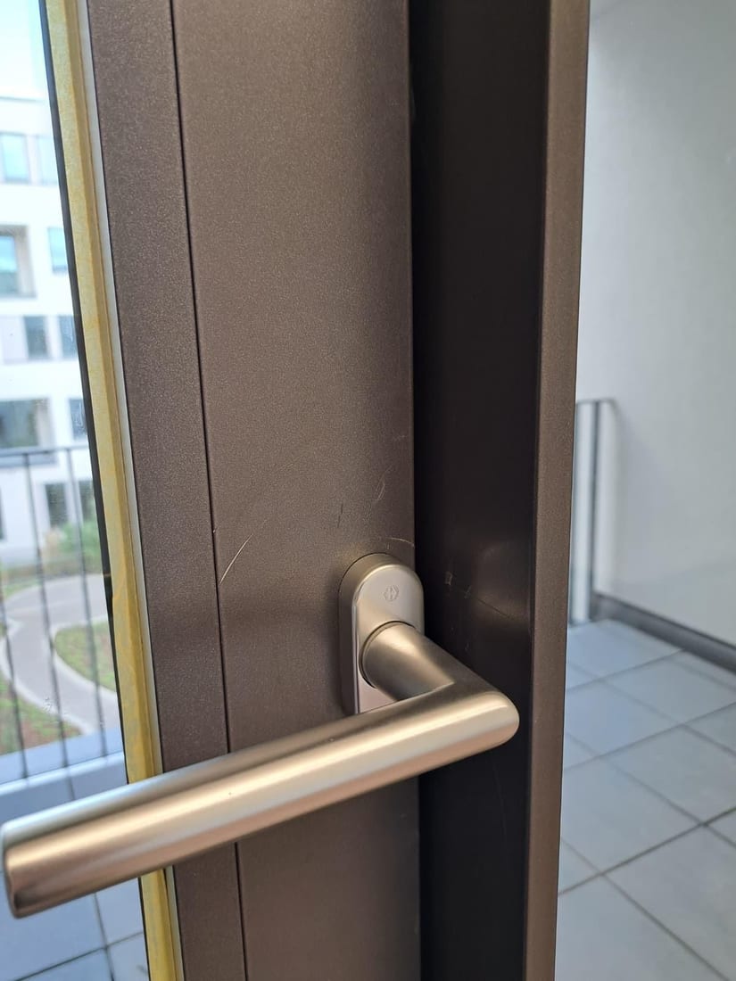 Coated door leaf beside the handle Before